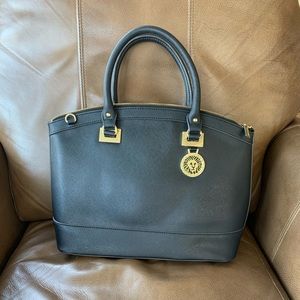 Anne Klein black purse with gold detail.
